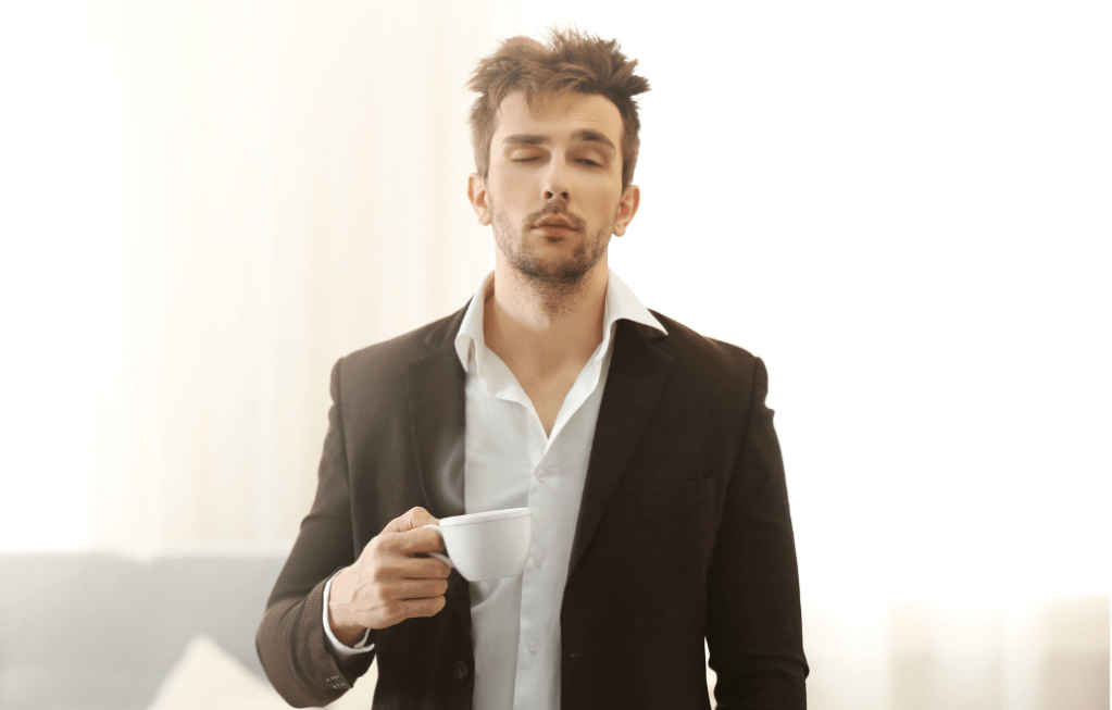 person holding coffee suffering from sleep inertia