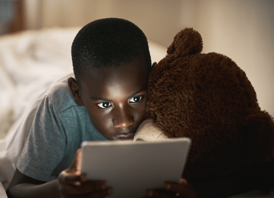 Boy playing on his iPad tablet